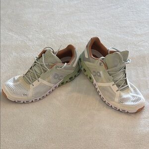 On Running Cream and Green Athletic Shoes